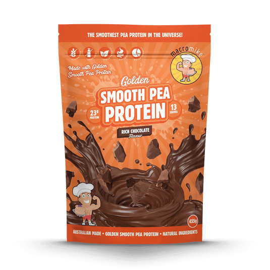 A stand-up pouch of Macromite Golden Smooth Pea Protein in Rich Chocolate Flavor, featuring a bright orange background with a large chocolate splash graphic and the Macromite mascot logo.
